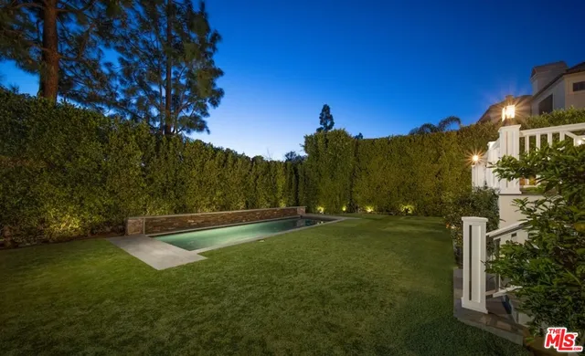 a view of a swimming pool with an outdoor space and seating area