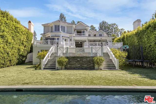 a view of a swimming pool with a yard