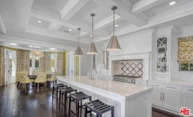 a large kitchen with a table and chairs