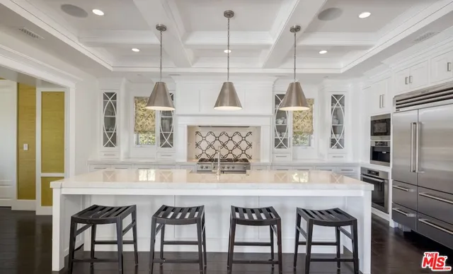 a kitchen with a table chairs refrigerator and microwave