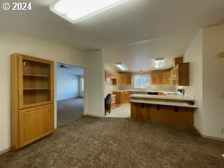 1923 18th Street Baker City, OR 97814 - Photo 6 of 15 a kitchen with stainless steel appliances kitchen island granite countertop a refrigerator and a stove