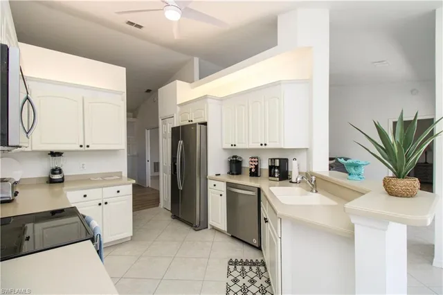 a kitchen with a sink stove and refrigerator