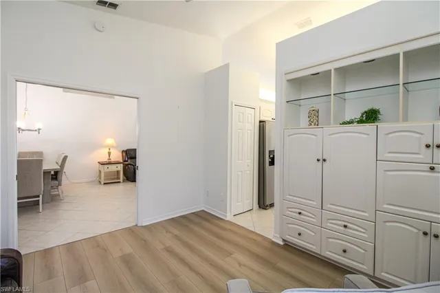 a view of a hallway with closet and cabinet
