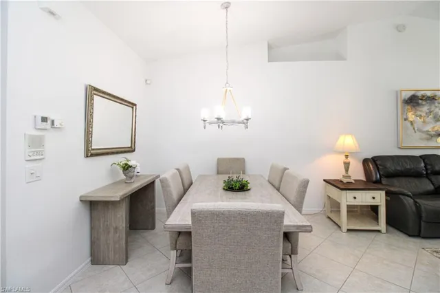 a dining room with table chairs and wooden floor