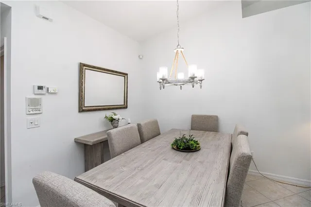 a living room with furniture a chandelier and a table