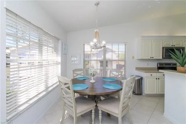a view of a dining room with furniture and chandelier