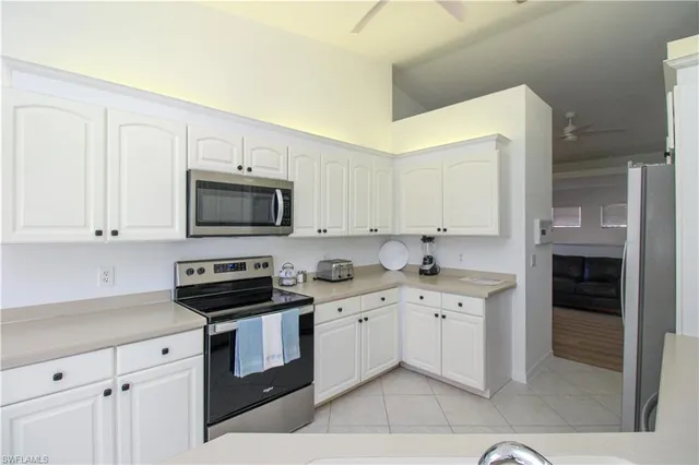 a kitchen with stainless steel appliances a sink stove and cabinets