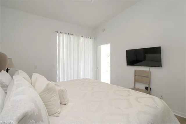 a bedroom with a flat screen tv and a bed