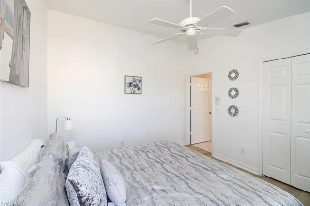 a bedroom with a bed and a ceiling fan