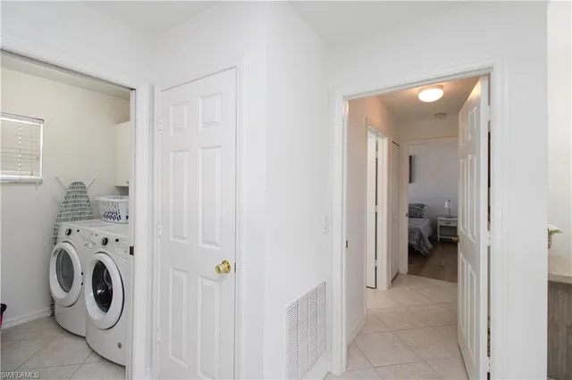 a view of a hallway with washer and dryer