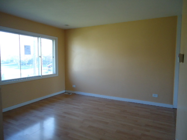 343 Gehrig Circle Bolingbrook, IL 60440 - Photo 2 of 16 a view of an empty room with wooden floor and a window