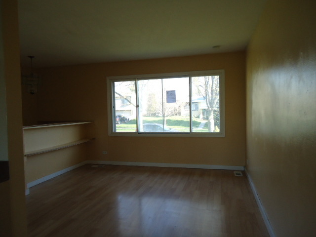 343 Gehrig Circle Bolingbrook, IL 60440 - Photo 5 of 16 an empty room with wooden floor and windows