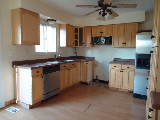 343 Gehrig Circle Bolingbrook, IL 60440 - Photo 7 of 16 a kitchen with stainless steel appliances granite countertop a sink a stove a refrigerator cabinets and a window