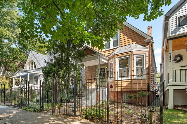 a view of a large house with a tree