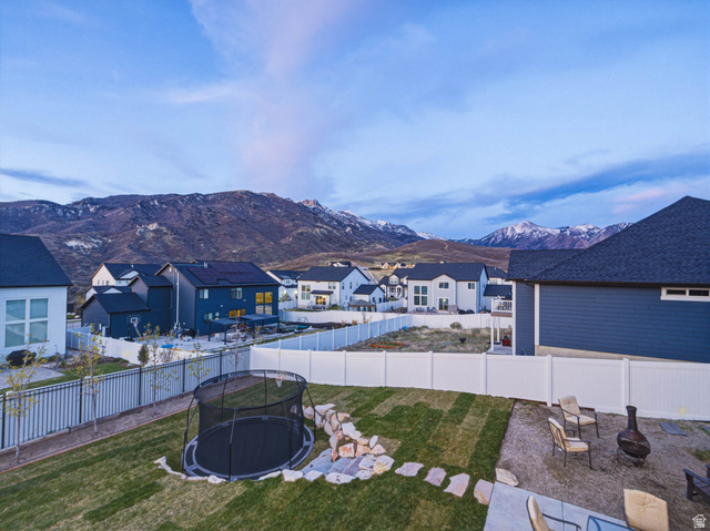 2487 Canyon Wild Road, Unit 413 Draper, UT 84020 - Photo 74 of 75 Fenced backyard featuring a residential view, a mountain view, and a fire pit