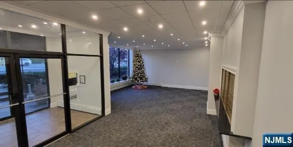 a view of a hallway with stainless steel appliances