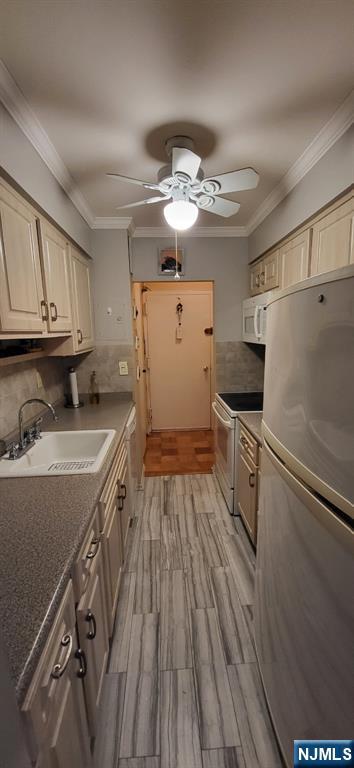 44 Main Street, Unit 6F Lodi, NJ 07644 - Photo 7 of 14 a kitchen with granite countertop a refrigerator a sink dishwasher and white cabinets with wooden floor