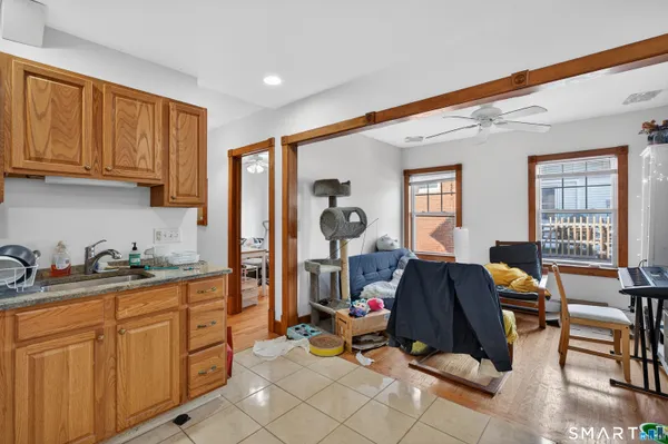 a living room with furniture a window and gym equipment