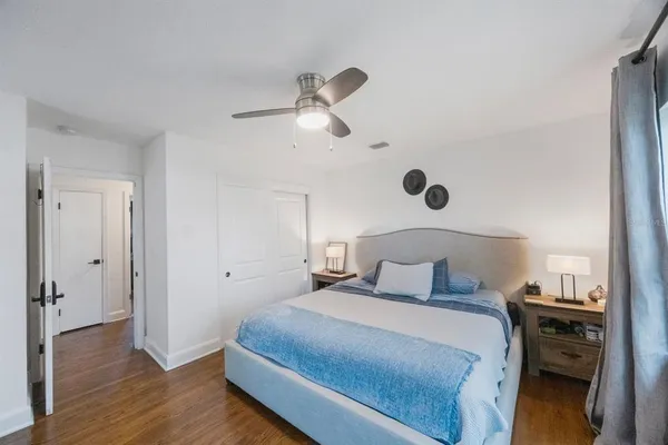 a bedroom with a bed and a chandelier