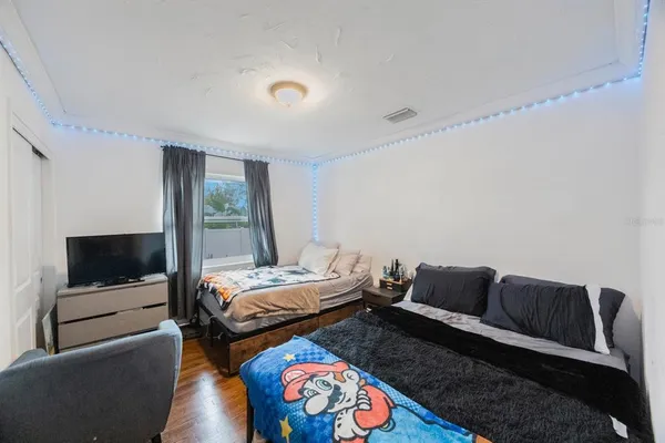 a bedroom with furniture and a flat screen tv