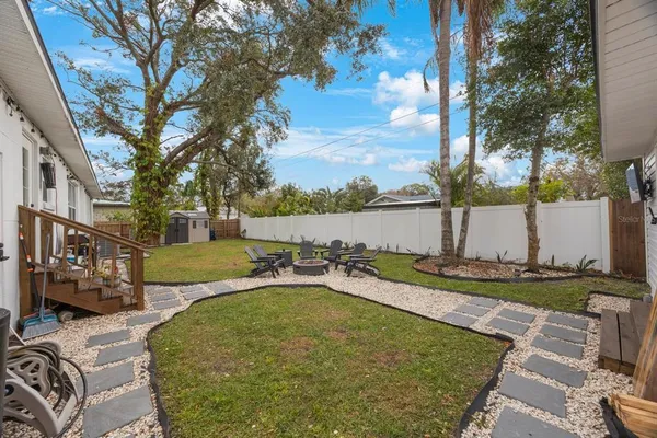 a view of a backyard with a garden and trees