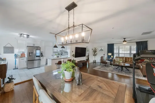 a living room with fireplace furniture and a chandelier