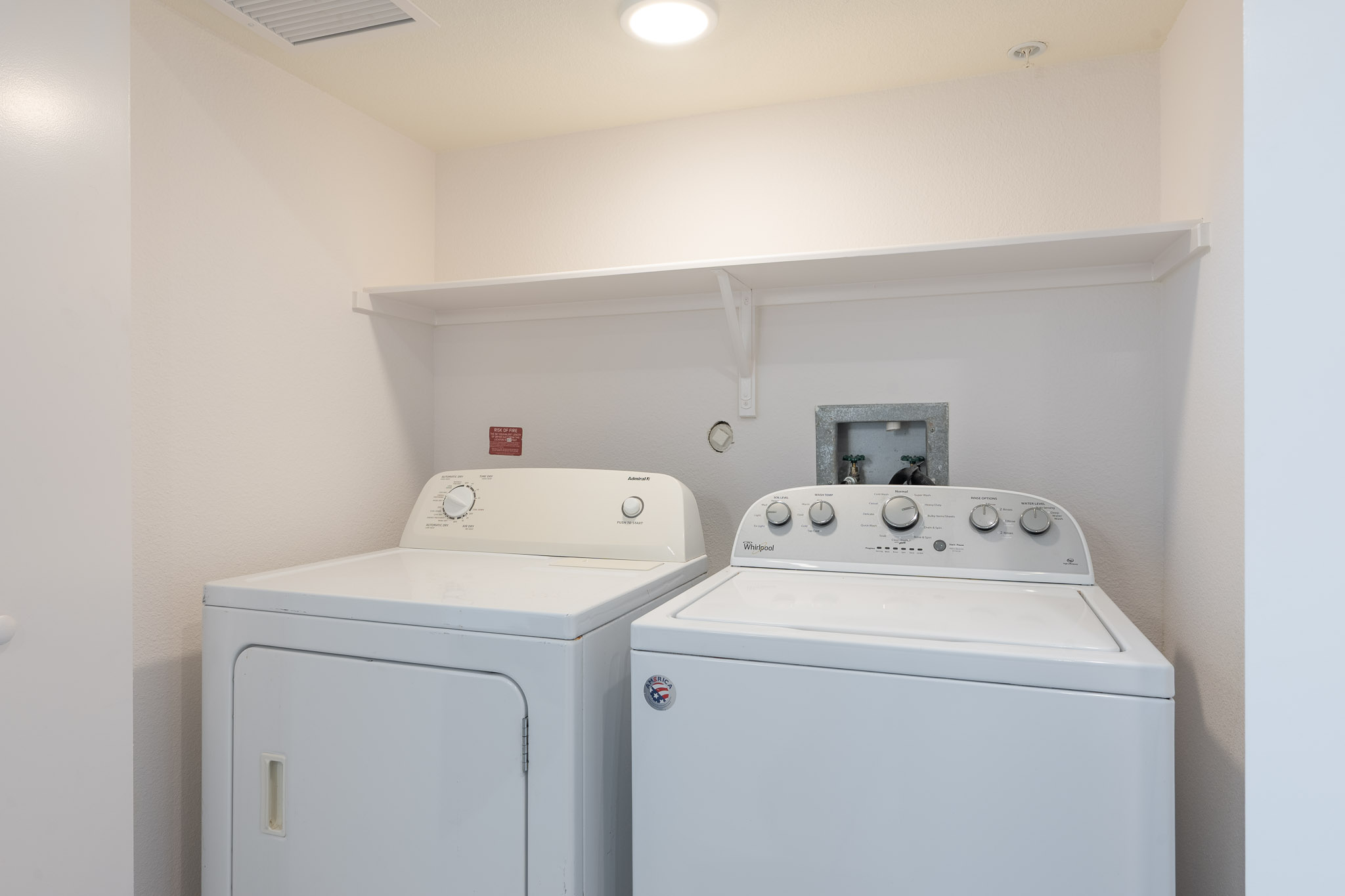 6700 Menchaca Road, Unit 20 Austin, TX 78745 - Photo 8 of 20 A well-appointed utility area featuring a practical shelf above the washer and dryer.