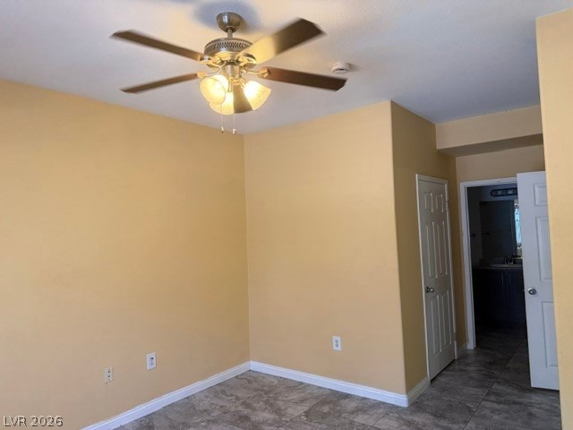 3318 North Decatur Boulevard, Unit 1163 Las Vegas, NV 89130 - Photo 22 of 35 A well-lit bedroom features a stylish ceiling fan with integrated lighting and durable tile flooring.