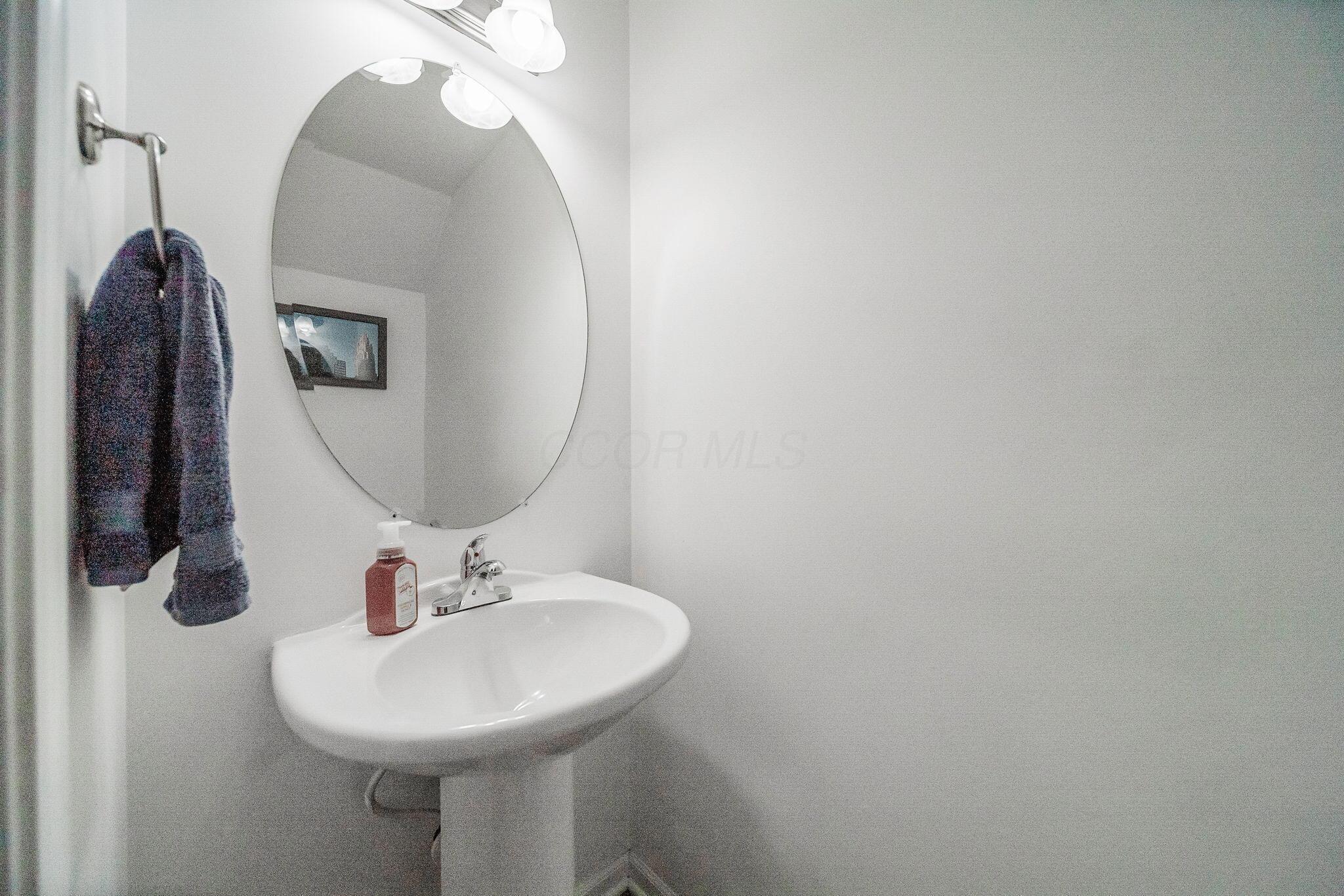 6186 Needletail Road, Unit 66 Columbus, OH 43230 - Photo 27 of 48 Powder room, located in the finished lower level is convenient and tidy.