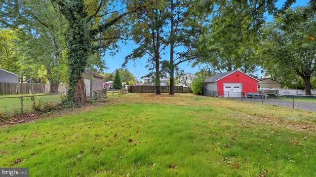 a view of yard with tree and wooden fence