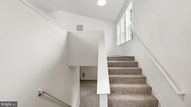 a front view of a house with a yard table and chairs