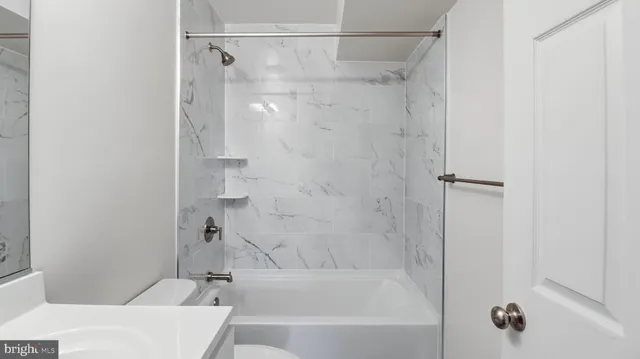 a bathroom with a bathtub and a shower