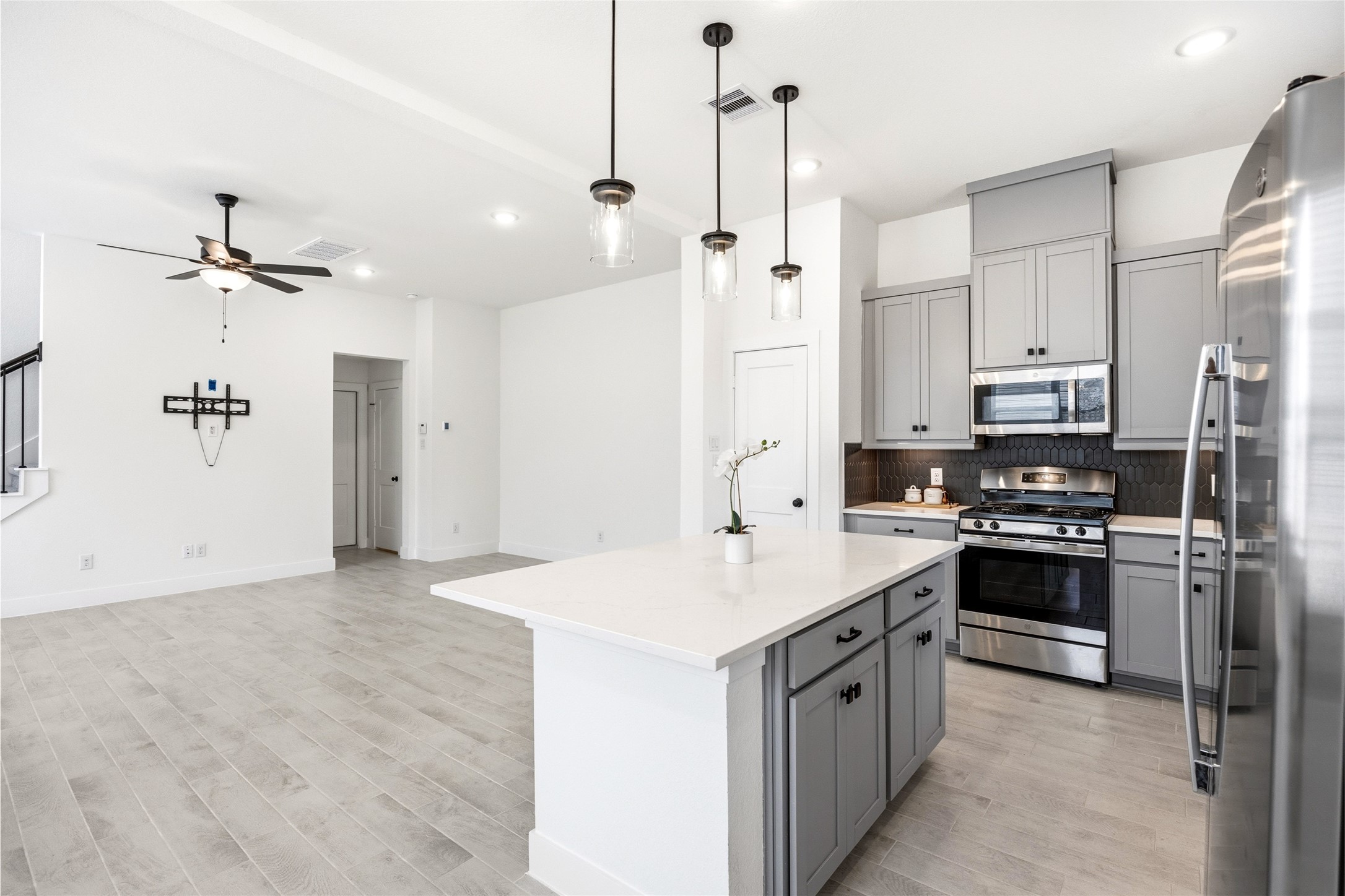 219 Prairie Rose Court Conroe, TX 77318 - Photo 11 of 49 a kitchen with kitchen island white cabinets and stainless steel appliances