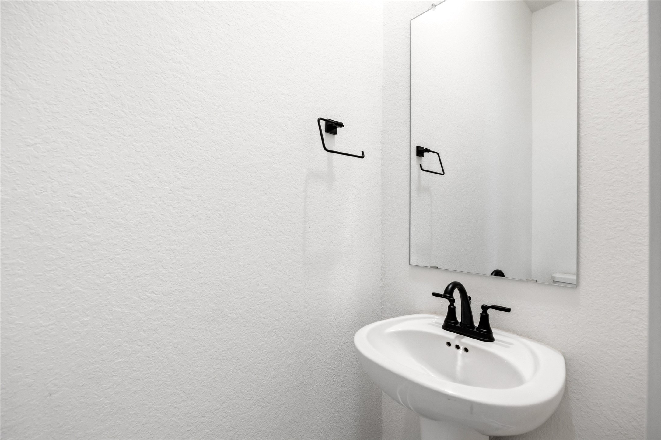 219 Prairie Rose Court Conroe, TX 77318 - Photo 16 of 49 a bathroom with a sink and mirror