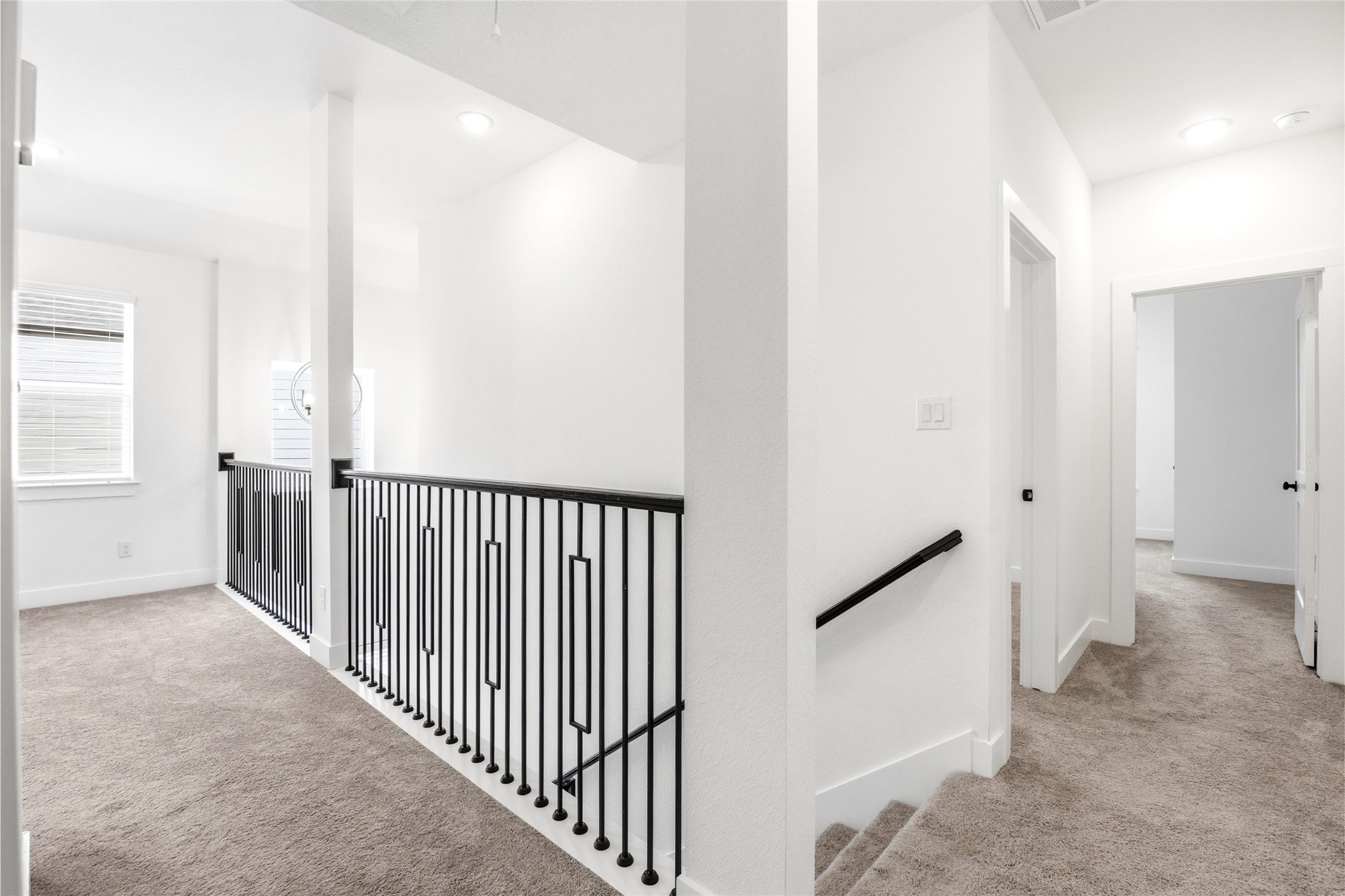 219 Prairie Rose Court Conroe, TX 77318 - Photo 18 of 49 a view of a hallway with white walls and stairs