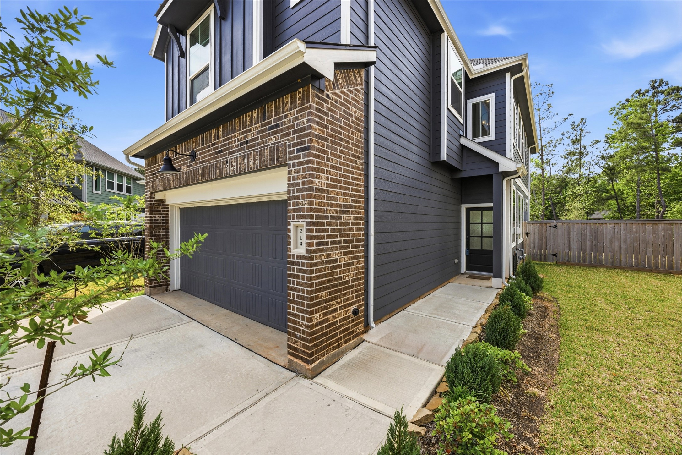 219 Prairie Rose Court Conroe, TX 77318 - Photo 2 of 49 a front view of a house with garden