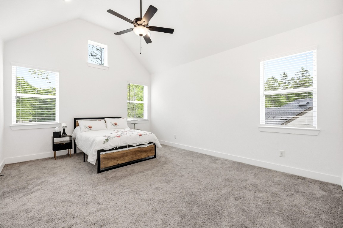 219 Prairie Rose Court Conroe, TX 77318 - Photo 27 of 49 a spacious bedroom with a bed and a window