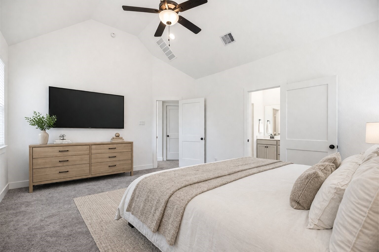 219 Prairie Rose Court Conroe, TX 77318 - Photo 28 of 49 a bedroom with a bed and flat screen tv