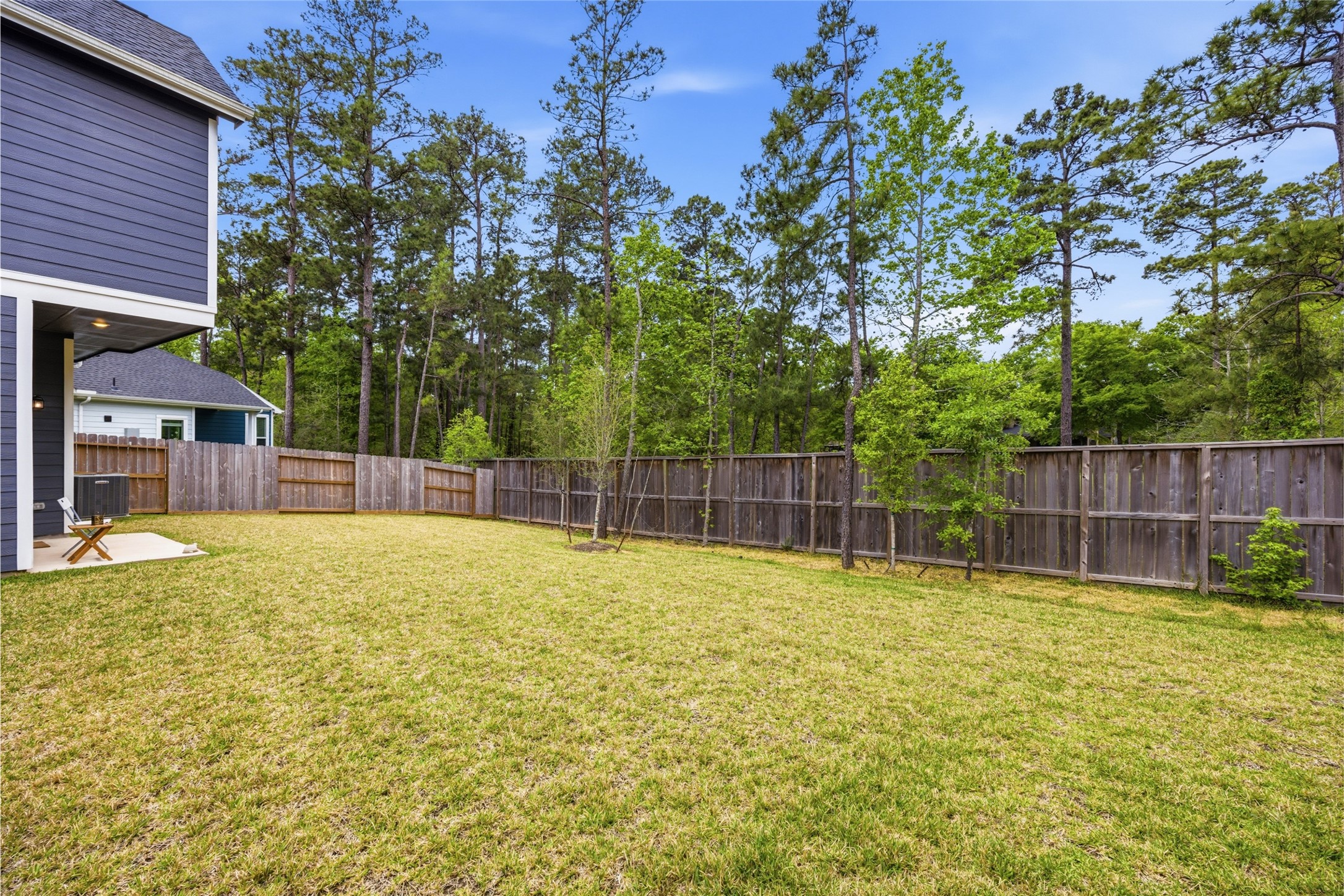 219 Prairie Rose Court Conroe, TX 77318 - Photo 3 of 49 a swimming pool with trees in the background