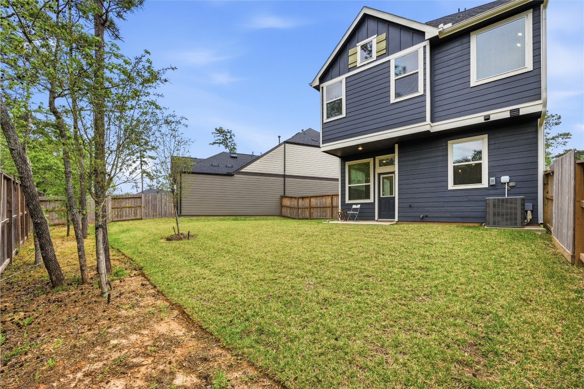 219 Prairie Rose Court Conroe, TX 77318 - Photo 33 of 49 a front view of a house with garden