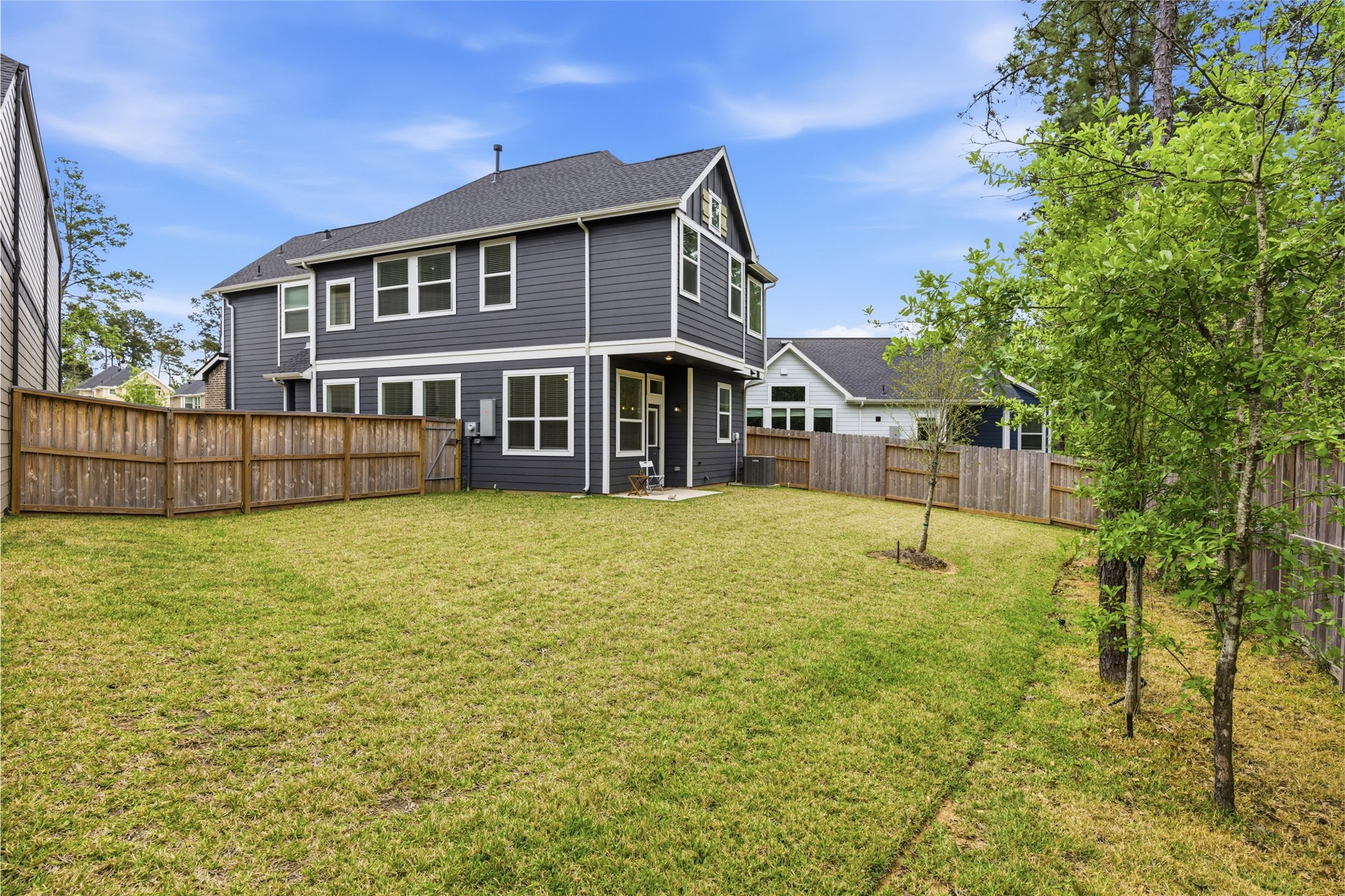 219 Prairie Rose Court Conroe, TX 77318 - Photo 34 of 49 a view of a house with a backyard