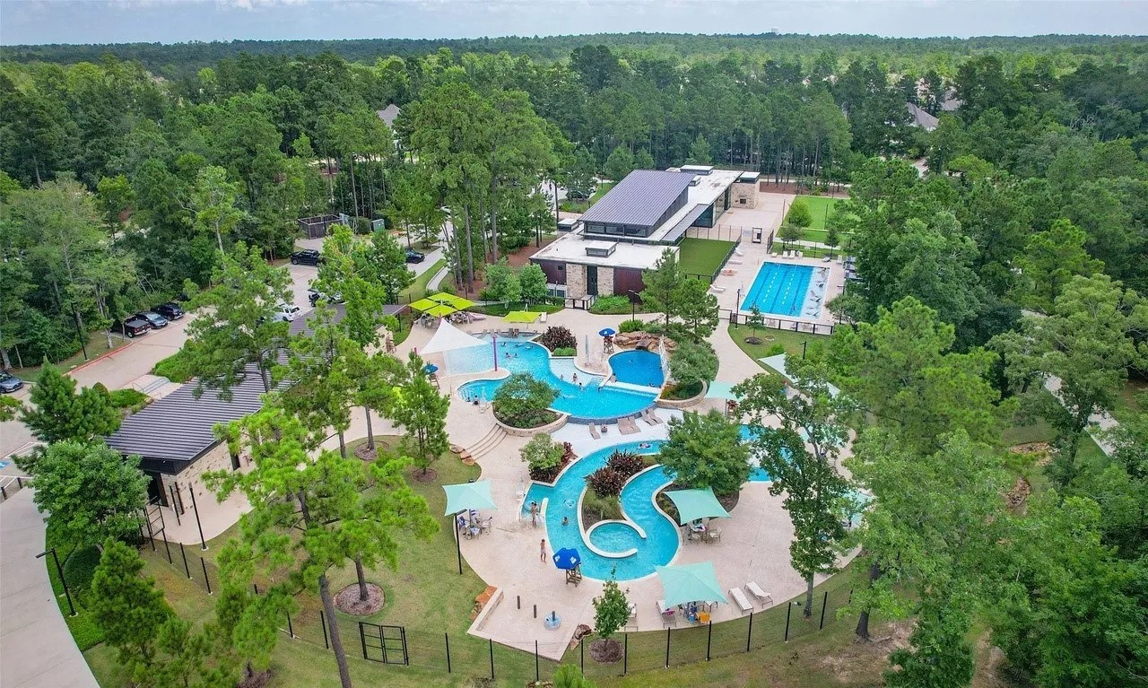 219 Prairie Rose Court Conroe, TX 77318 - Photo 37 of 49 an aerial view of a house with a yard and lake view