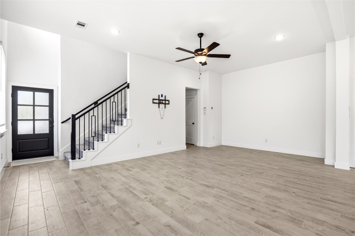 219 Prairie Rose Court Conroe, TX 77318 - Photo 8 of 49 a view of a hallway with a chandelier fan and entryway