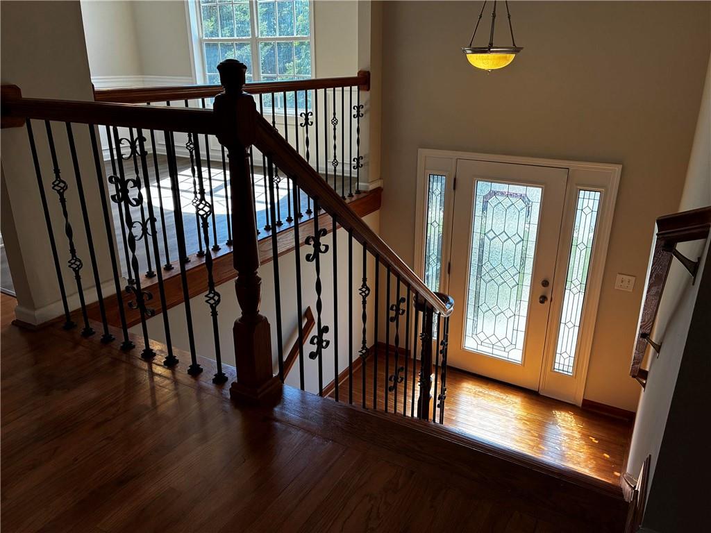 337 Madison Avenue Hampton, GA 30228 - Photo 4 of 32 a view of staircase with railing and white walls with wooden floor
