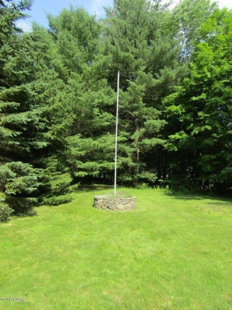 227 Hemlock Grove Road Newfoundland, PA 18445 - Photo 46 of 49 a backyard of a house with a table and chairs