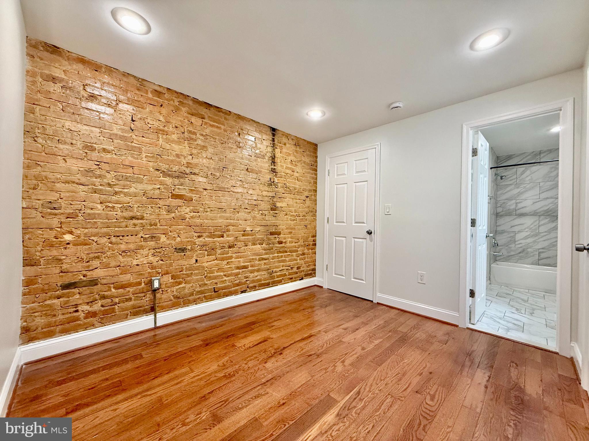 1268 Glyndon Avenue Baltimore, MD 21223 - Photo 13 of 30 a view of a livingroom with wooden floor and a bathroom
