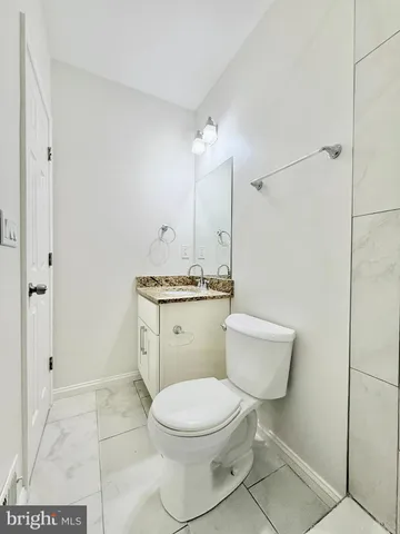 a white toilet sitting next to a bathroom sink