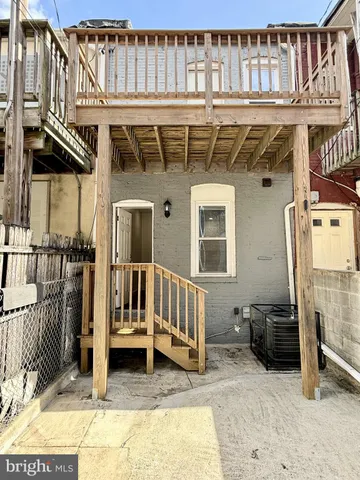 a view of a house with a wooden deck