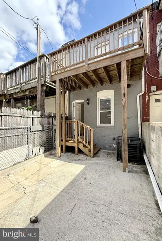 a view of a house with a wooden roof deck