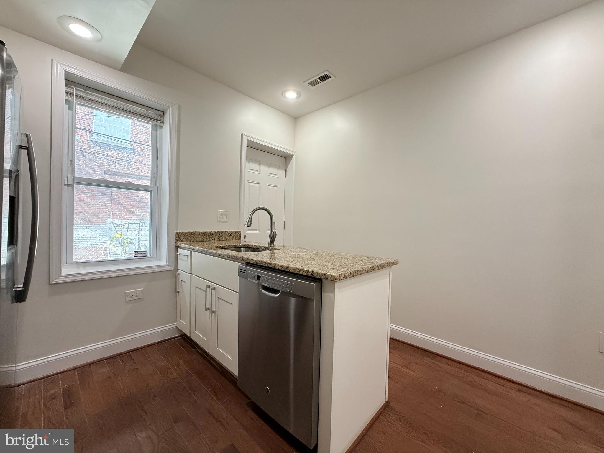 1268 Glyndon Avenue Baltimore, MD 21223 - Photo 10 of 30 a kitchen with sink stove and window